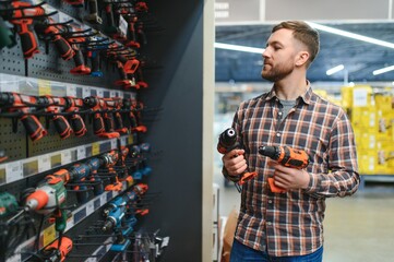 Portrait of happy mature man standing in hardware store