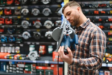 Portrait of happy mature man standing in hardware store