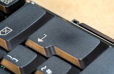 Man pressing an enter key on a laptop computer keyboard, finger pushing the key object macro...