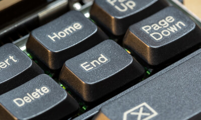 End button key on a simple laptop computer keyboard, macro detail, extreme closeup, nobody. Ending, the end, finishing a task, taking a break from activity, ceasing abstract concept symbol, nobody