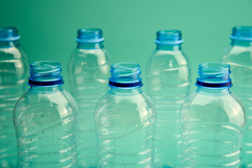 Green background and plastic bottles for recycling.