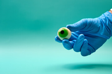 Prosthetic eyeball in hand of anonymous ophthalmologist