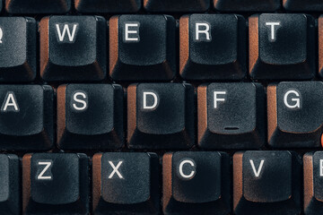 Old retro style aesthetic laptop computer keyboard with thick keys, top view shot from above, nobody, no people. Retro computing, typing writing text input simple abstract concept, many keys top down