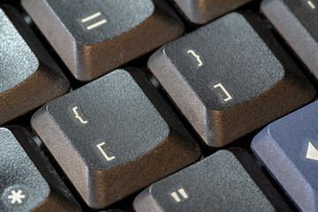 Curly brackets and square brackets, bracket symbol keys on a black computer keyboard, object macro, extreme closeup. Computer programming languages generic symbol, data structures list dict concept