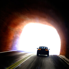 Car Driving Through Tunnel and Entering Light of Freedom
