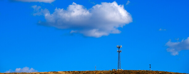 Radio Tower Telecommunications Blue Sky and Clouds - 780706286
