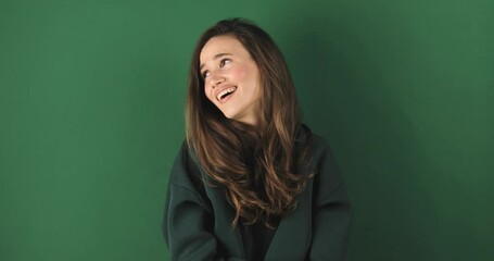 Fake, crying woman face in studio with hands gesture for sad, bullying or gesture on green background. Tears, face and female joke, cry and sign on mockup with unhappy boo emoji or fist of loser. - Powered by Adobe