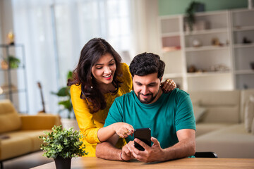 Indian asian smart and young couple using smartphone for call of for social media