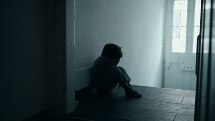 Five-Year-Old Boy Grappling with Emotional Despair, Seated Alone in Dark Corridor, Covering Face...