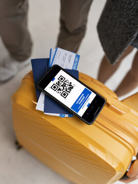 qr code on cell phone, plane tickets, boarding card, traveler vacations