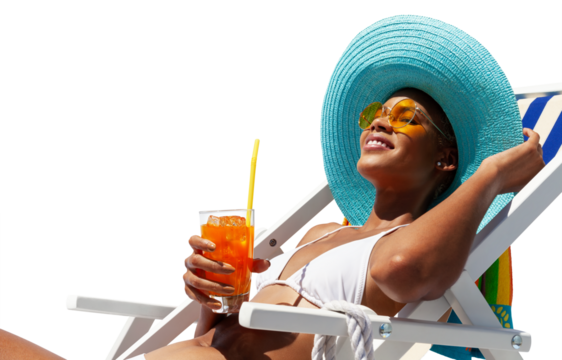 Happy woman is sunbathing on a beach deck chair, wearing sun hat and sunglasses, drinking a orange juice isolated on white background, concept of a summer beach holiday, booking travel and resort