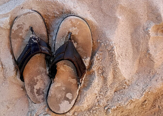 Men’s sandals on beach sand