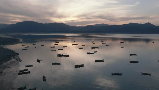 Khanpur Dam Lake Aerial Sunset View, Pakistan. Boats in water and Mountainsd on Background