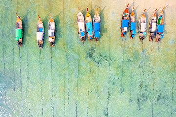 Aerial view big low tide in sea, traditional thai longtail boats stranded of Phi Phi island, Thailand