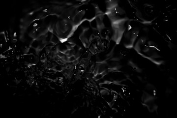 Image of black water surface with waves.