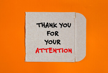 Thank you for your attention words written on torn paper piece with orange background. Conceptual...