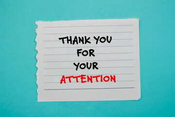 Thank you for your attention words written on torn paper piece with blue background. Conceptual business symbol. Copy space.