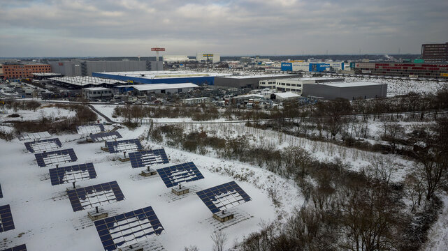 Weiterstadt, Germany January 19, 2024: View over the Weiterstadt commercial area with solar cells, metro, Segmüller in winter with snow