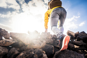 Hiker climbing mountains - Close up of successful climber standing on the top the of cliff - Focus on shoes - 780741226