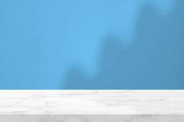 White Marble Table with Light Beam, Shadow, and Spotlight on the Blue Concrete Wall Background,...