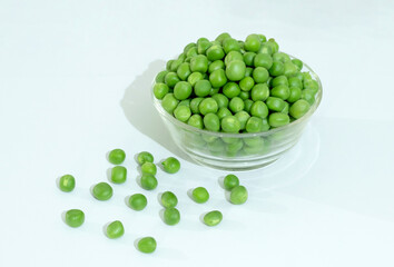 Green Peas - Matar on white Background. Green peas in Glass Bowl.