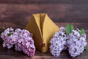 Festive card with an order, St. George's ribbon, flowers and a military cap. May 9, Victory Day...