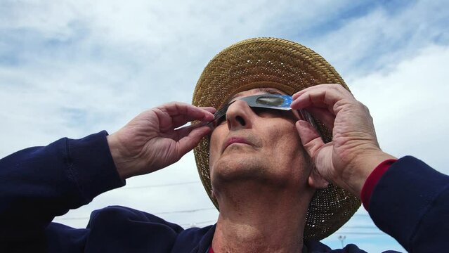 Man is watching American eclipse with protective glasses