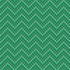 Green knitted seamless tileable pattern. Knitted fabric texture. Realistic knit texture for wallpaper, background, wrapping paper.