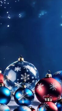 A collection of festive Christmas baubles in red and blue hues shines against a deep blue wintery background, evoking holiday cheer.