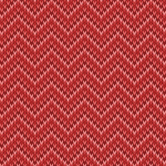 Red knitted seamless tileable pattern. Knitted fabric texture. Realistic knit texture for wallpaper, background, wrapping paper.