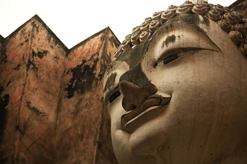 Wat Si Chum in Sukhothai Historical Park is a historic site big statue of Buddha Phra Achana...