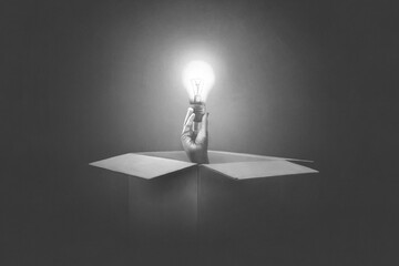 Illustration of hand holding light bulb coming out from a paper box, surreal concept
