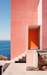 Overlooking the blue sea, the pink building has an orange door and a staircase leading up to it. (Architecture, Minimalist, Exterior, Mediterranean)