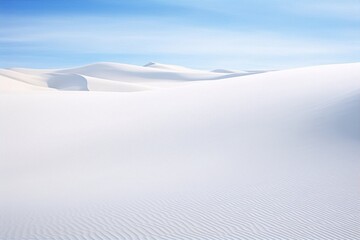 White sand dunes under a clear blue sky in the desert, creating a beautiful and serene landscape in the heart of nature