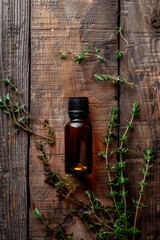thyme essential oil in a bottle. selective focus.