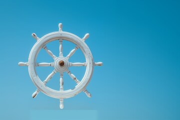 Close-up of a white wooden ship steering wheel isolated against a clear blue sky, symbolizing navigation and marine adventure.