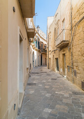 Fototapeta na wymiar Narrow street in the historic center of Lecce, urban center of Salento in Puglia, Italy