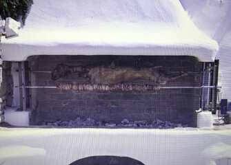 Easter in Greece is a traditional celebration. Cooking lamb on a spit. Close-up.