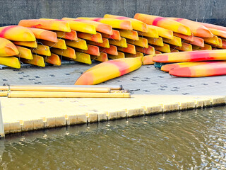 water sports, rows kayaks on the dock, beginning of summer kayaking sports season