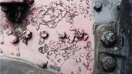 Background of damaged metal surface with bolts.