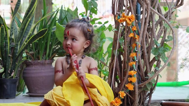 Cute Indian boy dresses as lord rama in action with bow at outdoor with from different angle at day