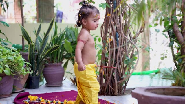 cute Indian boy with holy religious symbol on head at outdoor with from different angle at day