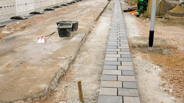 Laying paving stones - road construction site