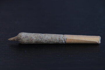 Marijuana joint on the table closeup and black background