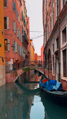 Medieval houses, narrow canals, bridges and gondolas in Venice, Italy, February 10, 2024. - 780800605