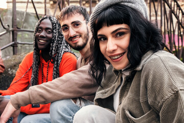 A multiethnic group of friends sharing a joyful selfie moment - young adult friends bond and...