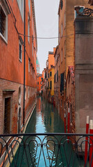 Medieval houses, narrow canals, bridges and gondolas in Venice, Italy, February 10, 2024. - 780805475