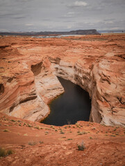 View overlooking Lake Powell surrounded by red rock sandstone canyon walls in Page Arizona