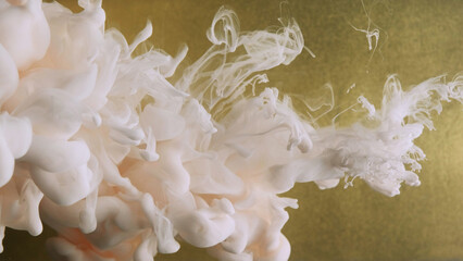Smoke splash. Ink drop explosion. White cloud vapor liquid texture paint flow on defocused gold color particles abstract background. - 780809680