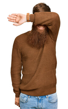 Young irish redhead man wearing casual clothes and glasses covering eyes with arm smiling cheerful and funny. blind concept.